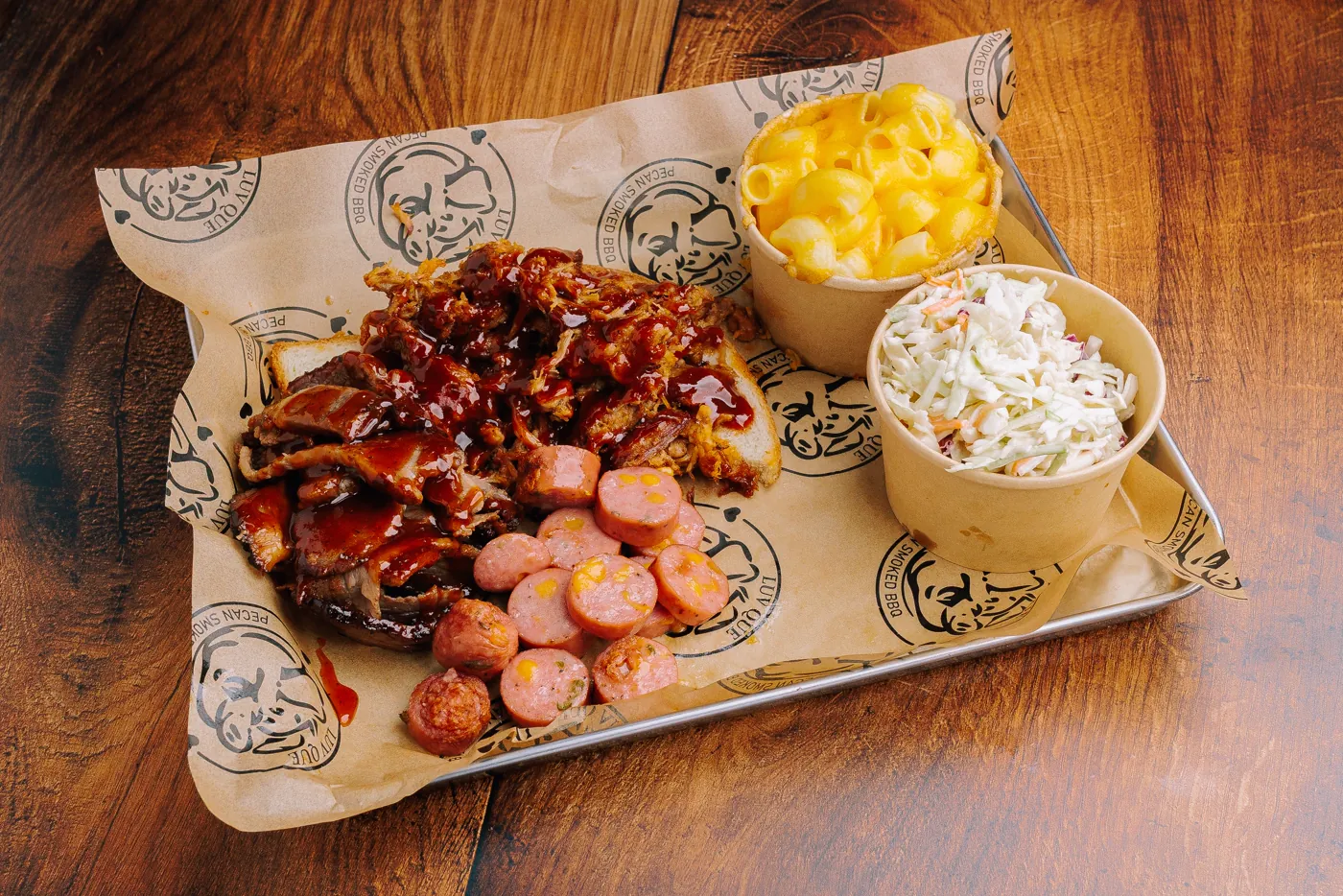 Three-meat platter with mac and cheese and coleslaw